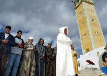 The Imam of the Sabaa Abouab mosque leads the faithful in Friday prayers outside the damaged mosque in the village of Ait Belaziz, 27 February 2004. Many of those afflicted by the earthquake remain angry with the authorities for responding too slowly and inefficently to the crisis. 
 AFP PHOTO/ABDELHAK SENNA