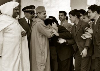 (FILES) A picture taken on January 27, 1958 shows Moroccan King Mohammed V (C) hugging a student as Education Minister Mohammed El Fassi looks on during King's visit to Moulay Idriss High school in Fez where he attends the UNESCO Congress of Arab states. AFP PHOTO