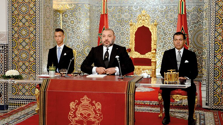 This handout picture courtesy the Moroccan Royal Palace shows Morocco's King Mohammed VI (C) delivering a speech to mark the 16th anniversary of his accession to the throne, beside his brother Prince Moulay Rachid (R) and son Hassan III (L) in Tetouan on August 29, 2017. / AFP PHOTO / MAP / MAP / == RESTRICTED TO EDITORIAL USE - MANDATORY CREDIT "AFP PHOTO / MOROCCAN ROYAL PALACE -Hand-Out" - NO MARKETING NO ADVERTISING CAMPAIGNS - DISTRIBUTED AS A SERVICE TO CLIENTS ==
