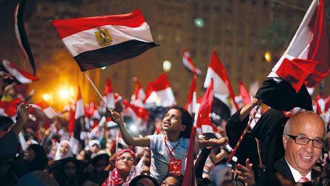 Protesters react after President Mohammed Morsi was ousted by the military on Wednesday in Tahrir Square in Cairo. The head of Egypt's armed forces General Abdel Fattah El Sissi issued a declaration suspending the constitution and appointing Egypt's chief justice as interim head of state.