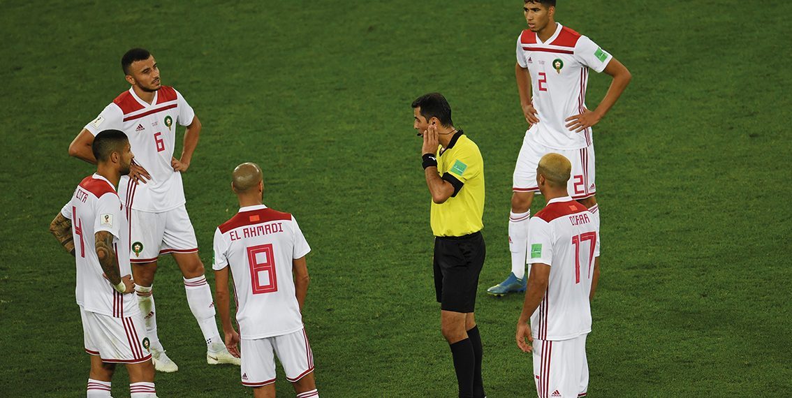 Uzbek referee Ravshan Irmatov (C) waits for the VAR goal review confirming Spain's second goal during the Russia 2018 World Cup Group B football match between Spain and Morocco at the Kaliningrad Stadium in Kaliningrad on June 25, 2018. / AFP PHOTO / OZAN KOSE / RESTRICTED TO EDITORIAL USE - NO MOBILE PUSH ALERTS/DOWNLOADS