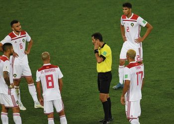 Uzbek referee Ravshan Irmatov (C) waits for the VAR goal review confirming Spain's second goal during the Russia 2018 World Cup Group B football match between Spain and Morocco at the Kaliningrad Stadium in Kaliningrad on June 25, 2018. / AFP PHOTO / OZAN KOSE / RESTRICTED TO EDITORIAL USE - NO MOBILE PUSH ALERTS/DOWNLOADS